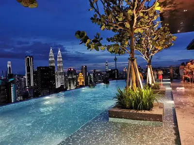 a infinity pool on the roof of a building with a city skyline at Expressionz Suite KL City Center KLCC in Kuala Lumpur