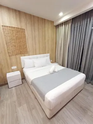 a bedroom with a large white bed in it at Bukit Ceylon Suites At RMAD KLCC in Kuala Lumpur