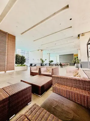a large room with couches and tables in a building at Bukit Ceylon Suites At RMAD KLCC in Kuala Lumpur