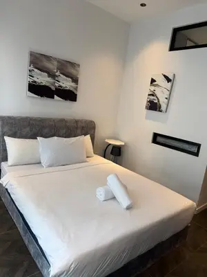 a bed with two towels on it in a room at Scarletz Suites KLCC by Dream in Kuala Lumpur