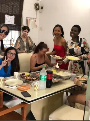a group of women sitting around a table eating food at Female Hostel wakakapacker in Kuala Lumpur