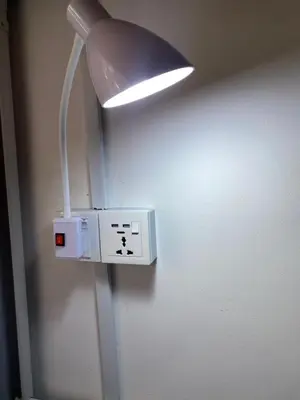 a light attached to a wall with a switch at Female Hostel wakakapacker in Kuala Lumpur