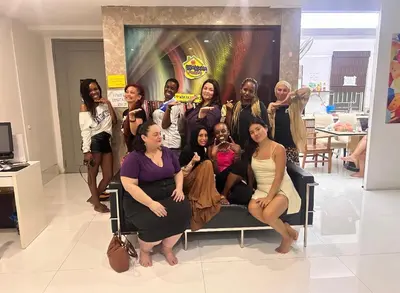 a group of women posing for a picture on a couch at Female Hostel wakakapacker in Kuala Lumpur