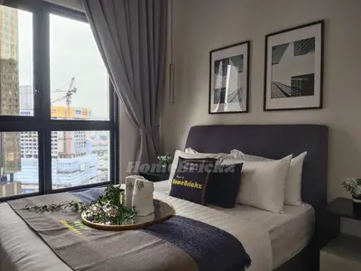 a bedroom with a bed with a large window at The Mews KLCC by Homebrickz in Kuala Lumpur
