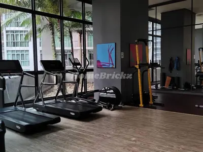 a gym with two exercise bikes and a treadmill at The Mews KLCC by Homebrickz in Kuala Lumpur