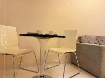 a table and two chairs and a couch at Damas Suite Sri Hartamas 4 pax Link to Mall in Kuala Lumpur