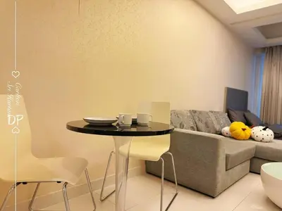 a living room with a table and a couch at Damas Suite Sri Hartamas 4 pax Link to Mall in Kuala Lumpur