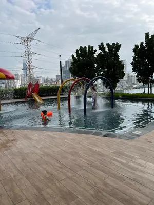 a child is playing in a water park at Ourstay M Vertica 49th floor Kuala Lumpur City View near Ikea with level 1 car park & 6 minutes walk to Maluri MRT in Kuala Lumpur