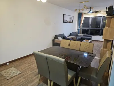a dining room and living room with a table and chairs at Ourstay M Vertica 49th floor Kuala Lumpur City View near Ikea with level 1 car park & 6 minutes walk to Maluri MRT in Kuala Lumpur