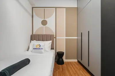 a small bedroom with a bed with a white bedspread at Trendy 3BR MVertica Near MRT by RumaBnB in Kuala Lumpur