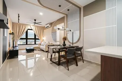 a kitchen and living room with a table and chairs at Trendy 3BR MVertica Near MRT by RumaBnB in Kuala Lumpur