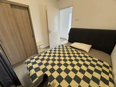 a bedroom with a bed with a checkeredkeredkered at lavile 3 \u623f in Kuala Lumpur