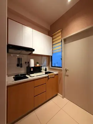 a kitchen with white cabinets and a stove at 10pax Comfy Homestay 5 Min-MITEC in Kuala Lumpur