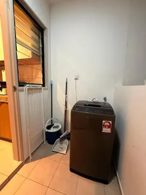 a small refrigerator in a room with a window at 10pax Comfy Homestay 5 Min-MITEC in Kuala Lumpur