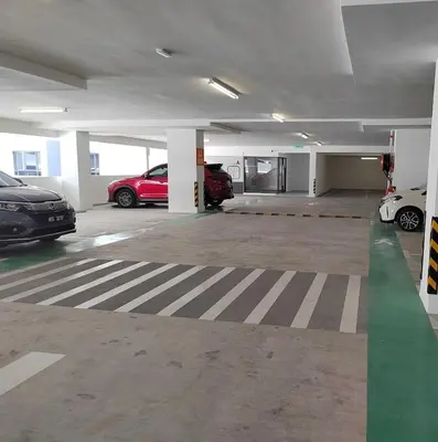 a parking garage with cars parked in it at 10pax Comfy Homestay 5 Min-MITEC in Kuala Lumpur