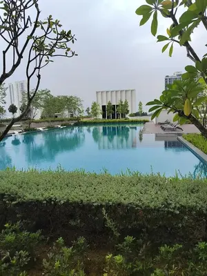 a large pool of blue water with buildings in the background at 10pax Comfy Homestay 5 Min-MITEC in Kuala Lumpur