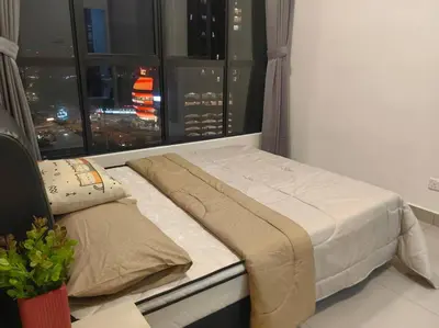 a bed in a room with a view of a city at lavile residence in Kuala Lumpur