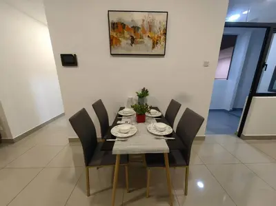 a dining room table with chairs and plates on it at lavile residence in Kuala Lumpur