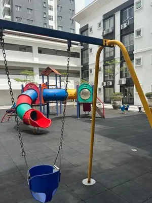 a playground with a swing in a courtyard at Cozy 2BR Apt AxisAtrium Mall wPool Pandan Indah Ampang Kuala Lumpur in Ampang