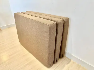 a couch sitting against a wall in a room at 7Pax Muji Continew KL Centre View 10mins to TRX KLCC IKEA in Kuala Lumpur
