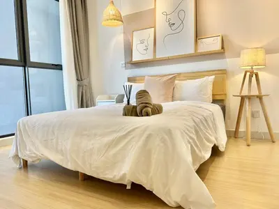 a bedroom with a large bed with a white comforter at 7Pax Muji Continew KL Centre View 10mins to TRX KLCC IKEA in Kuala Lumpur