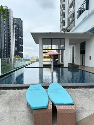 two blue benches sitting next to a pool with an umbrella at Skyline Homes by Reizz in Kuala Lumpur