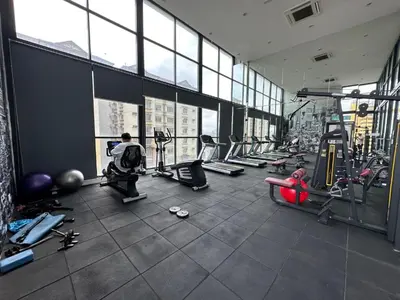 a gym with a bunch of equipment in a building at Skyline Homes by Reizz in Kuala Lumpur