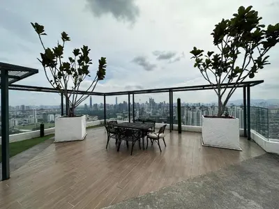 a balcony with a table and chairs on top of a building at Skyline Homes by Reizz in Kuala Lumpur