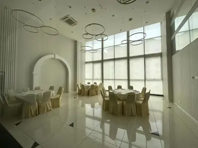a large room with tables and chairs and large windows at Skyline Homes by Reizz in Kuala Lumpur