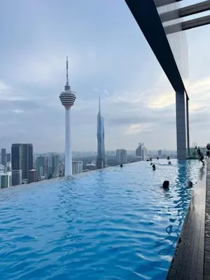 a infinity pool on the roof of a building with buildings at The Platinum kuala lumpur By MAJU in Kuala Lumpur