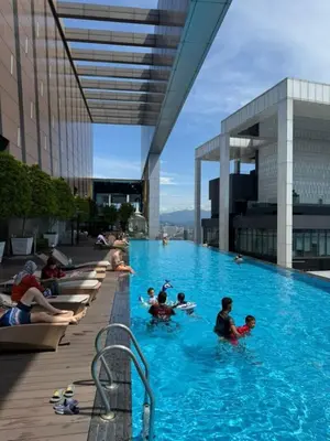 a group of people in a swimming pool on a building at The Platinum kuala lumpur By MAJU in Kuala Lumpur