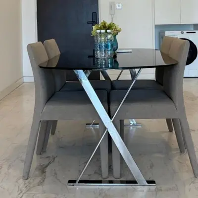 a dining table with a glass top and two chairs at The Platinum kuala lumpur By MAJU in Kuala Lumpur
