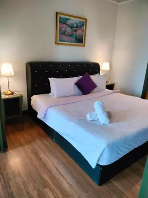 a bed with two stuffed animals on top of it at Quitecove Service Suite at Times Square KL in Kuala Lumpur