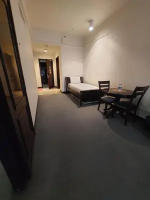 a room with a bed and a table and chairs at Rainfall Suite And Service at Time Squre KL in Kuala Lumpur