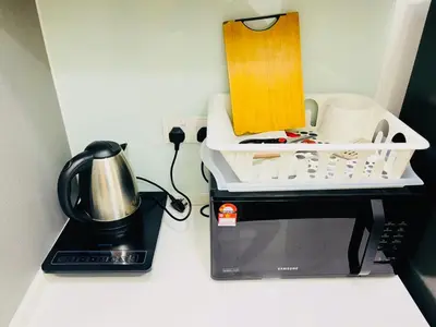 a kitchen counter with a coffee maker and a microwave at Colony Relax Residences Klcc in Kuala Lumpur