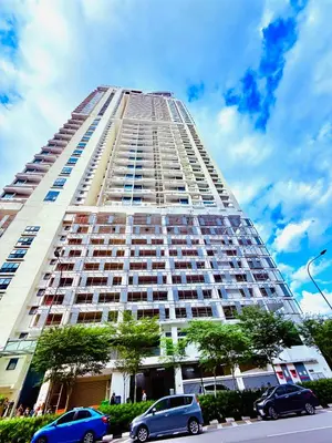 a tall building with cars parked in front of it at Colony Relax Residences Klcc in Kuala Lumpur
