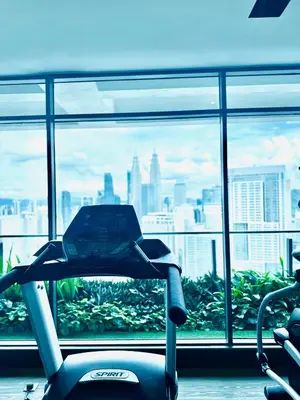 a gym with a view of a city skyline at Colony Relax Residences Klcc in Kuala Lumpur