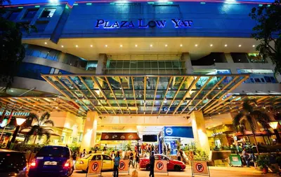 a large building with cars parked in front of it at CozyNest Suites Bukit Bintang in Kuala Lumpur