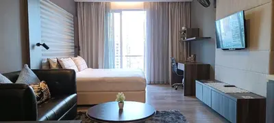 a hotel room with a couch and a bed and a television at CozyNest Suites Bukit Bintang in Kuala Lumpur
