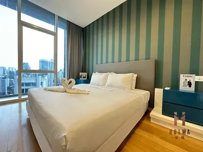 a bedroom with a bed with a stuffed animal on it at The Platinum KLCC by Holma in Kuala Lumpur