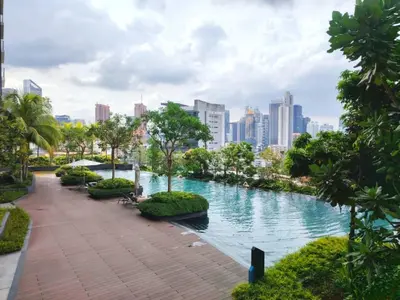 a river in the middle of a city with buildings at Residensi Continew 5 min walk MRT Train, TRX KL City Centre view Apartment in Kuala Lumpur