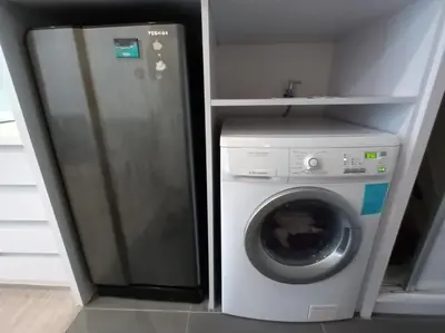 a refrigerator and a washing machine in a kitchen at AK Residence in Kuala Lumpur