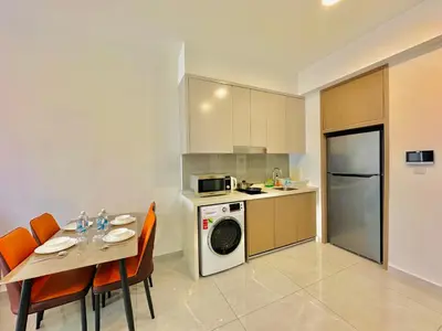 a kitchen with a table and a kitchen with a microwave at Agile Suites TRX KlCC in Kuala Lumpur
