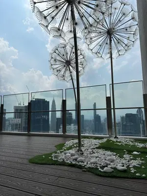 two umbrellas sitting on top of a building at Agile Suites TRX KlCC in Kuala Lumpur