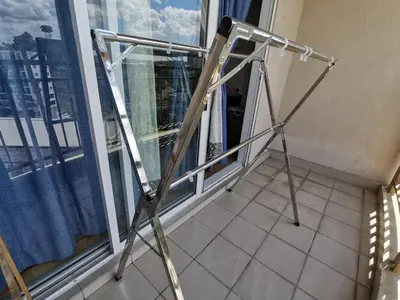 a folding ladder in front of a window at Cosy studio with King size bed \u9752\u65c5\u4e00\u65cf in Kuala Lumpur