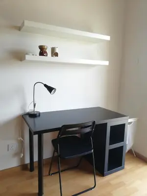 a black desk with a lamp and a chair at Cosy studio with King size bed \u9752\u65c5\u4e00\u65cf in Kuala Lumpur