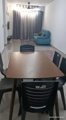 a table and chairs in a living room with a couch at LSH33 Condo DUKE Sentul KL in Kuala Lumpur