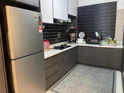 a kitchen with a stainless steel refrigerator and cabinets at LSH33 Condo DUKE Sentul KL in Kuala Lumpur