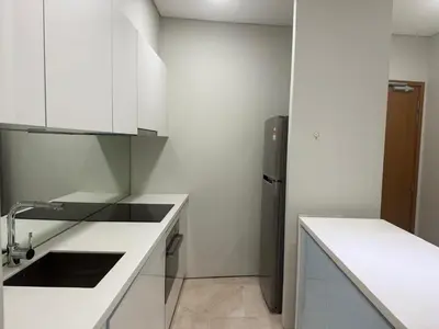a white kitchen with a sink and a refrigerator at Dawn Legacy Suite in Kuala Lumpur