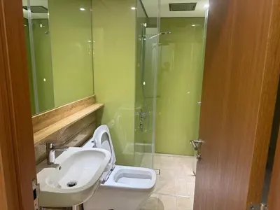 a bathroom with a sink and a toilet and a shower at Dawn Legacy Suite in Kuala Lumpur